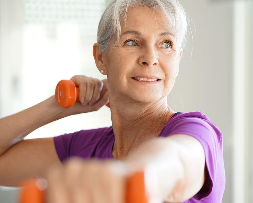 Middle aged woman working out in a gym.