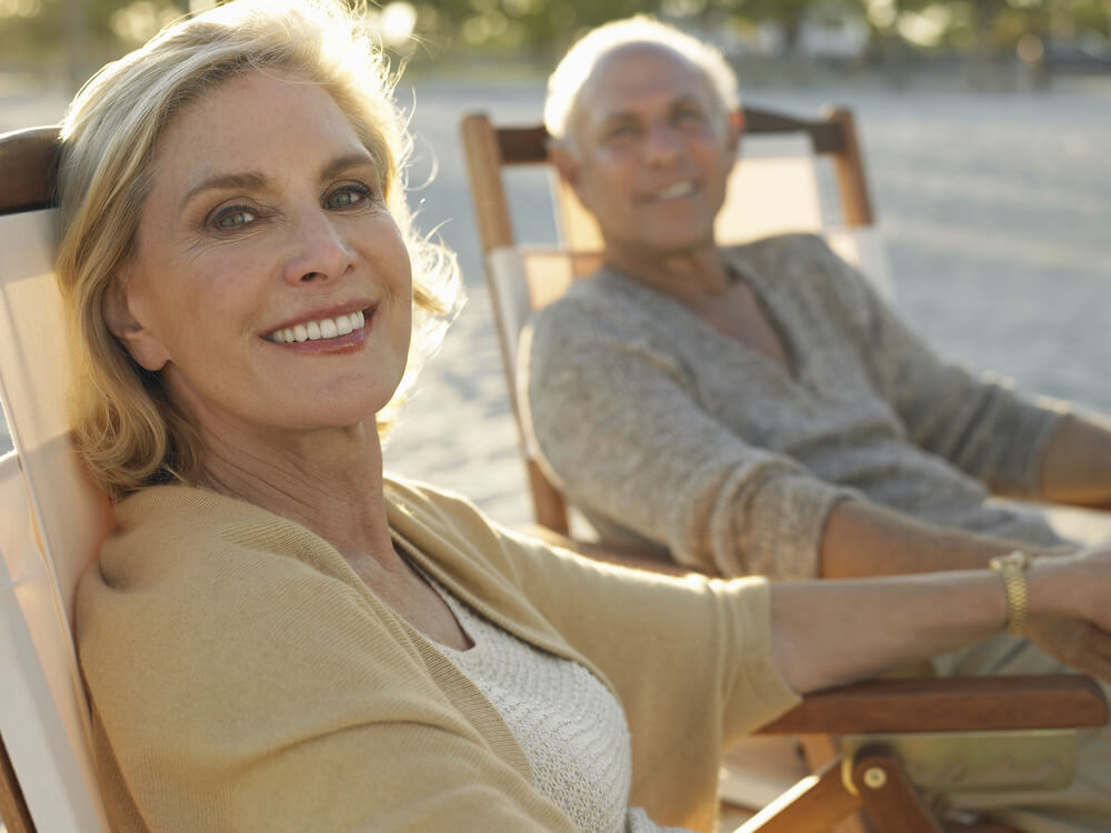 couple in beach chairs holding hands