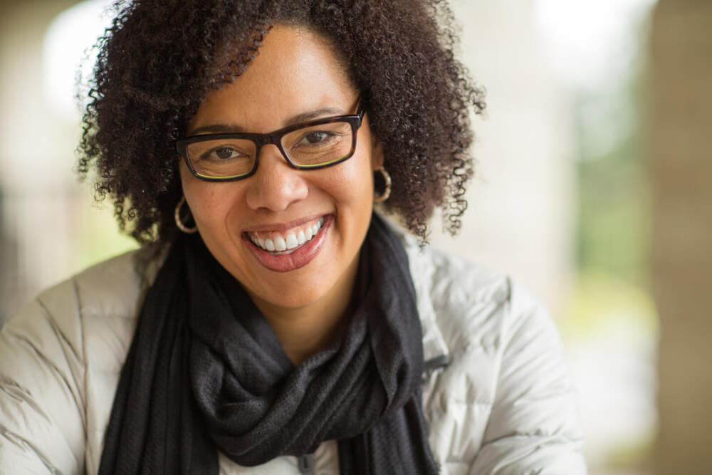 middle-age woman wearing glasses smiling