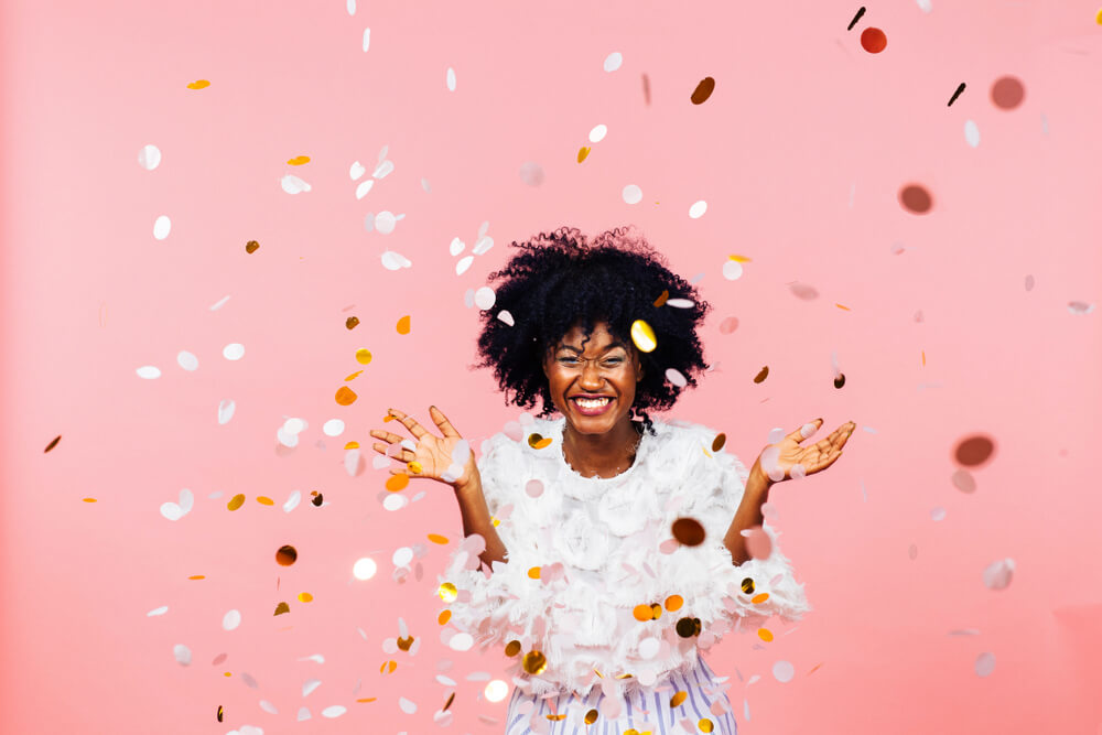 Happy woman surrounded by confetti