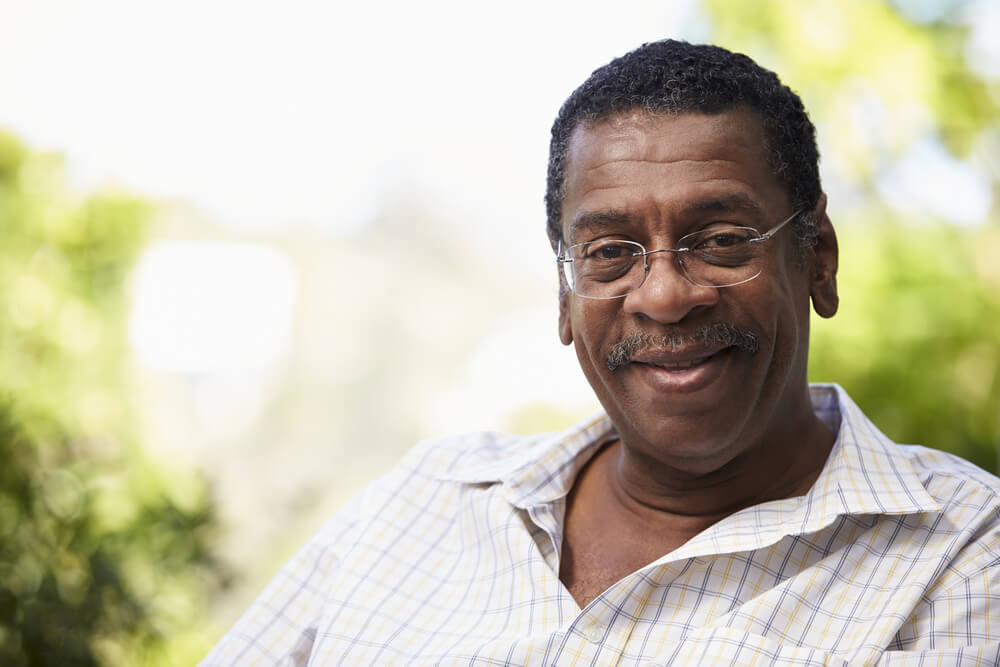 Older man wearing glasses relaxing outside